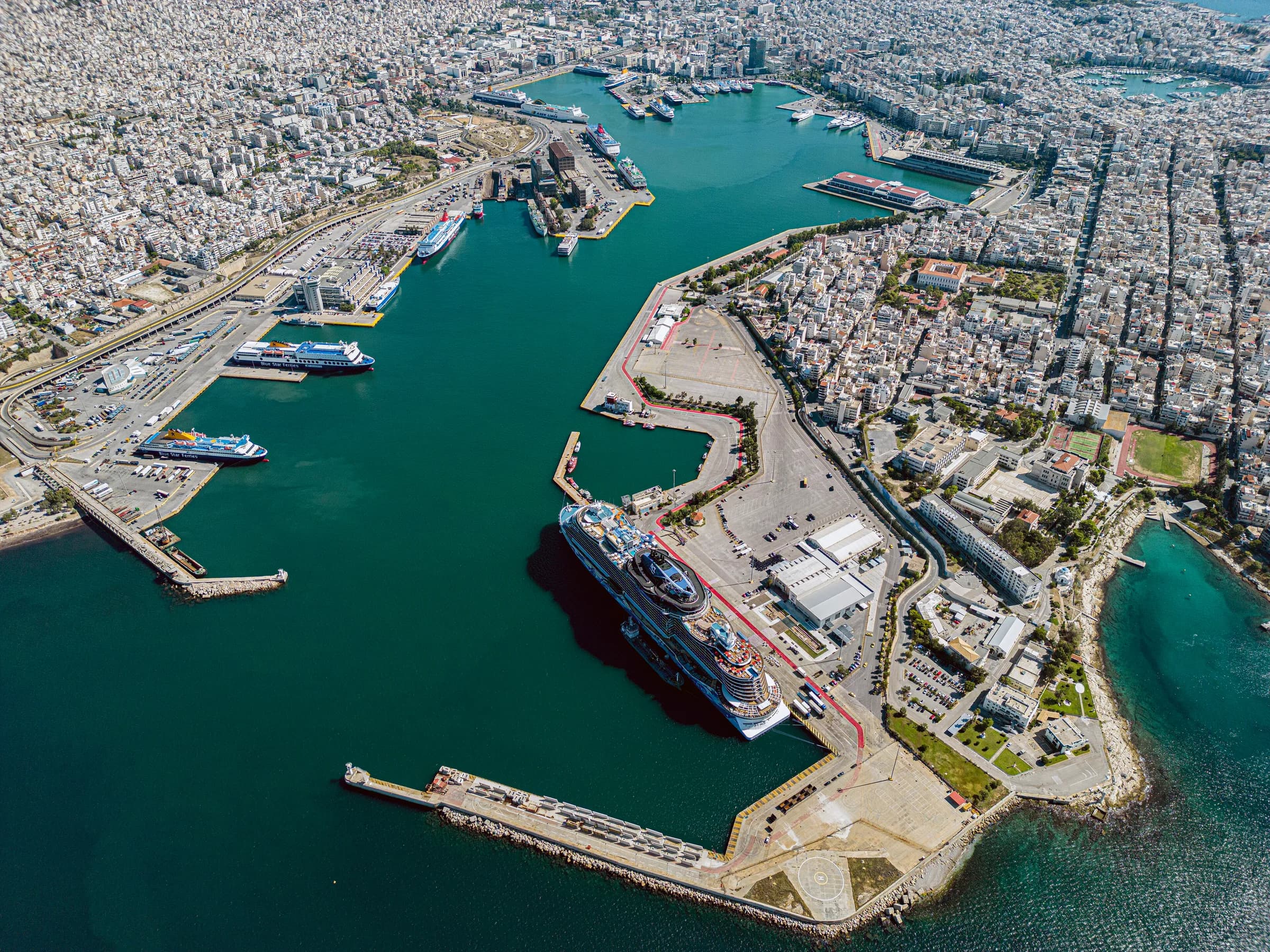 Ferries and cruise ships docked at the Port of Piraeus at sunset, Greece